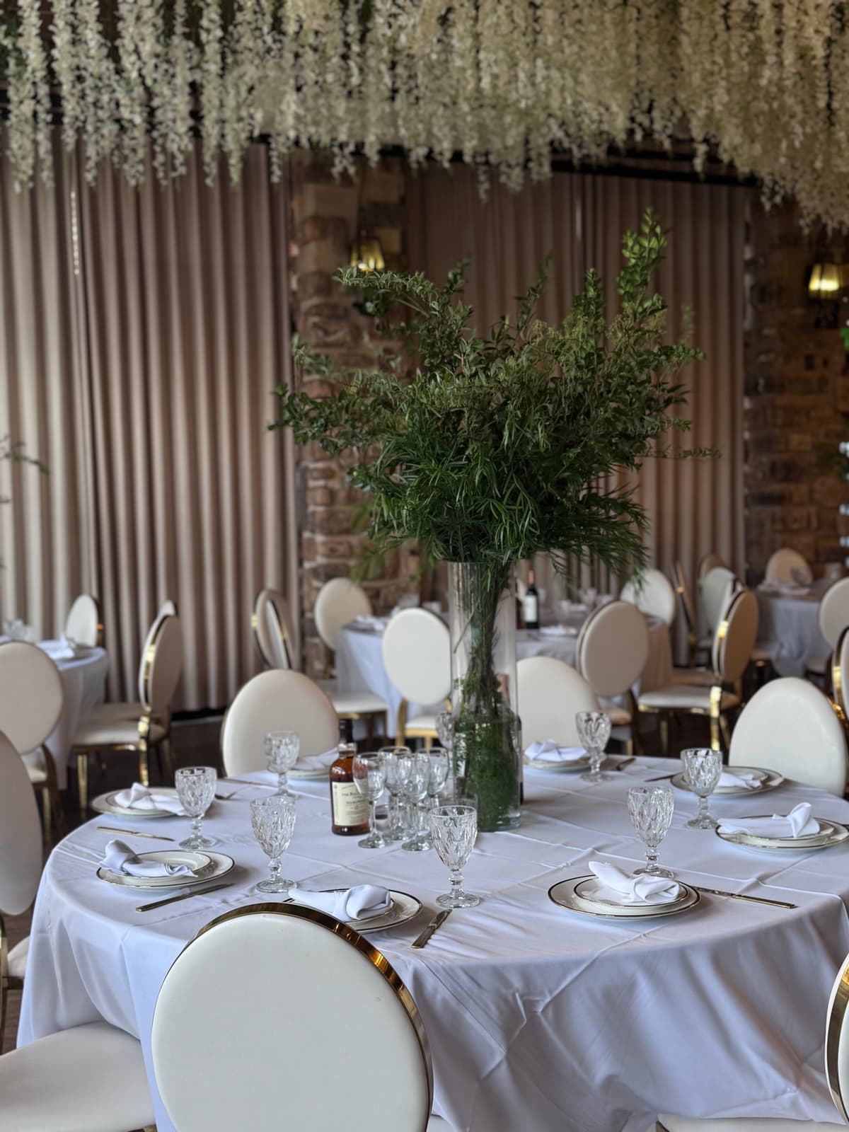 Elegant table setting with floral centerpiece and gold-rimmed place settings